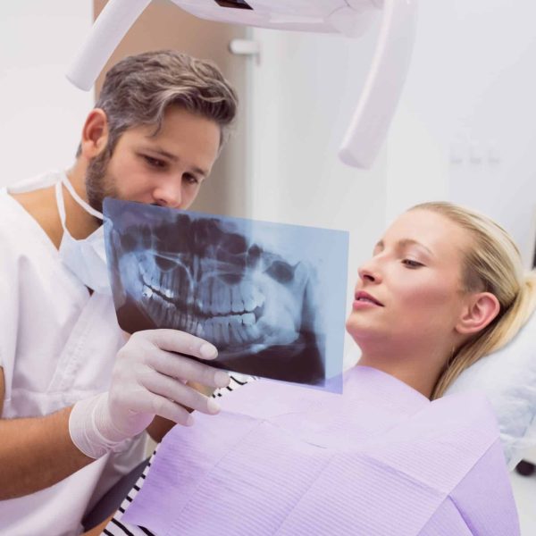 dentist-showing-x-ray-patient