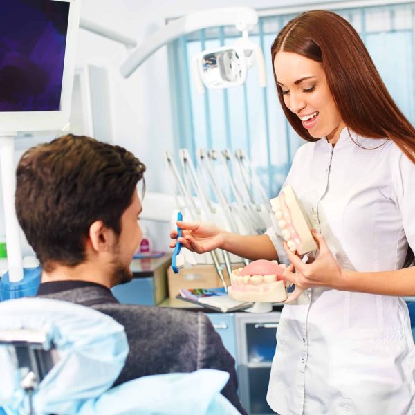 Professional woman dentist doctor working . Man at dental clinic. man at dentist taking care of teeth.
